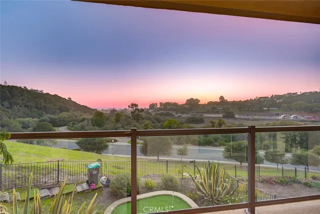 a view of a big house with a big yard and large trees