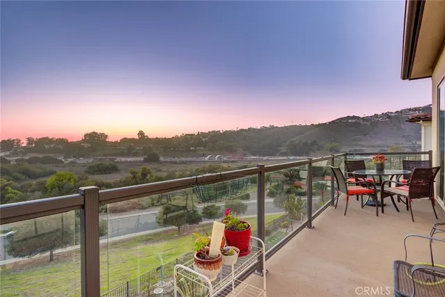 a view of a big house with a big yard and potted plants