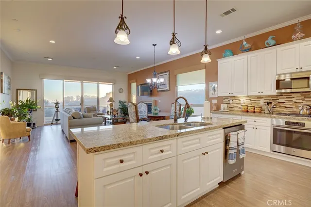 a dining room with furniture a chandelier and wooden floor