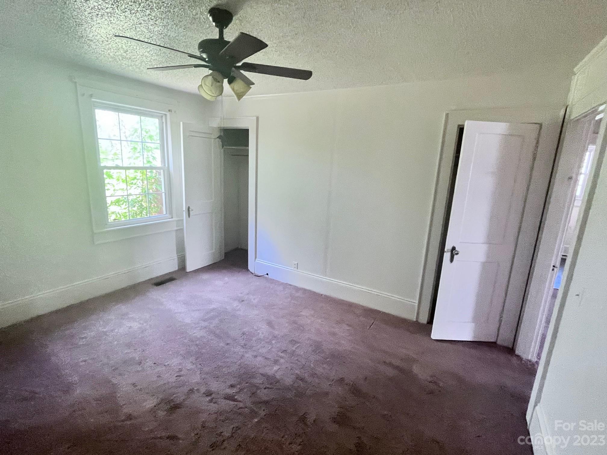 110 Webb Road Shelby, NC 28152 - Photo 11 of 19 an empty room with windows and fan