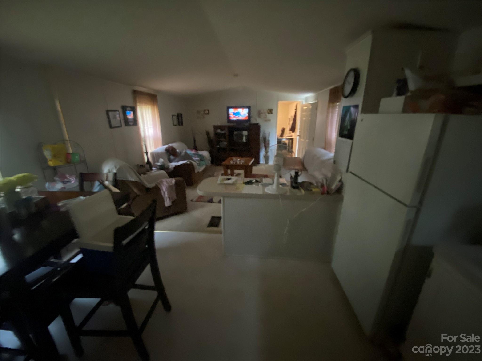 110 Webb Road Shelby, NC 28152 - Photo 19 of 19 a living room with chairs and a refrigerator