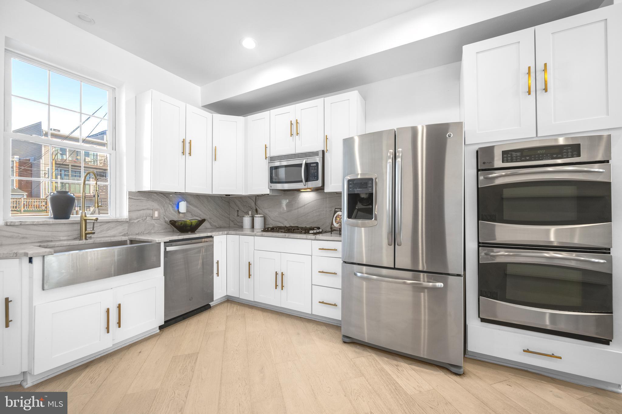 41 R Street Northwest Washington, DC 20001 - Photo 11 of 43 a kitchen with granite countertop a refrigerator stove and sink
