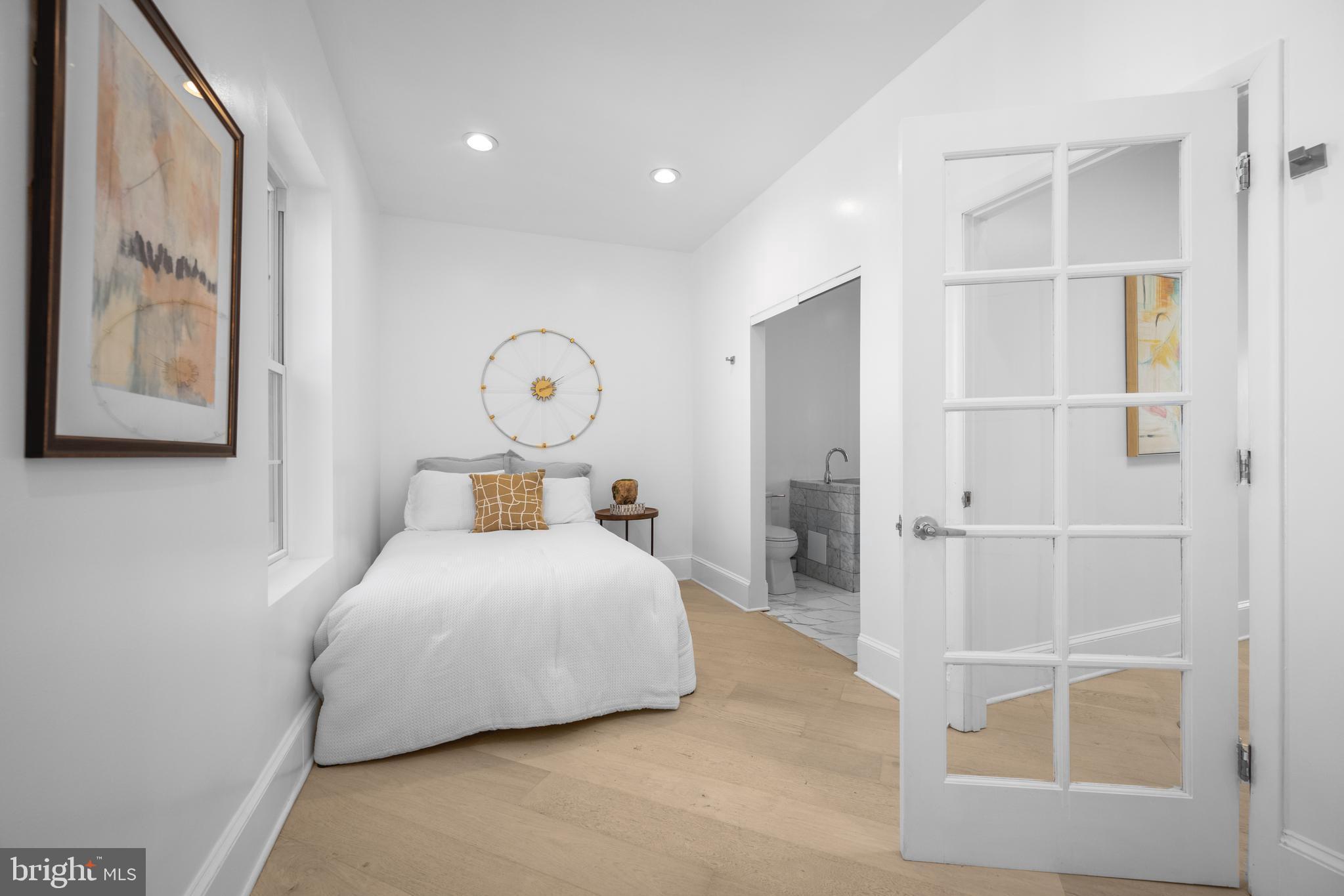 41 R Street Northwest Washington, DC 20001 - Photo 26 of 43 a bedroom with a bed and a large window