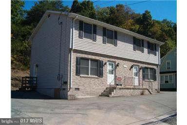 297 Martinsburg Road Berkeley Springs, WV 25411 - Photo 1 of 1 a front view of a house with garage