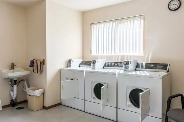 a kitchen with a stove a sink and a refrigerator