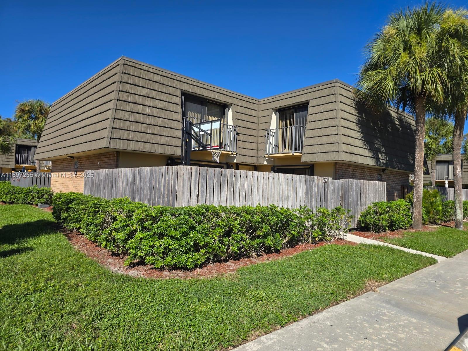 a view of a house with a yard and plants