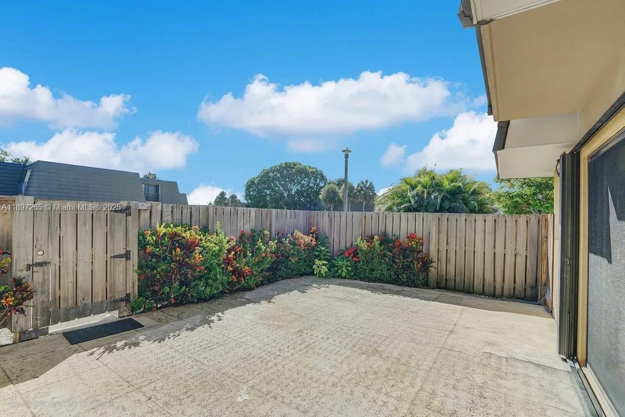 629 6th Way West Palm Beach, FL 33407 - Photo 2 of 10 a view of garden with wooden fence