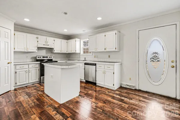a kitchen with white cabinets and stainless steel appliances