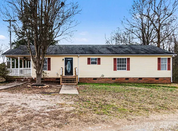 a backyard of a house with barbeque oven