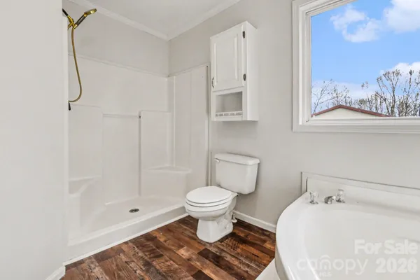 a bathroom with a white toilet and a shower