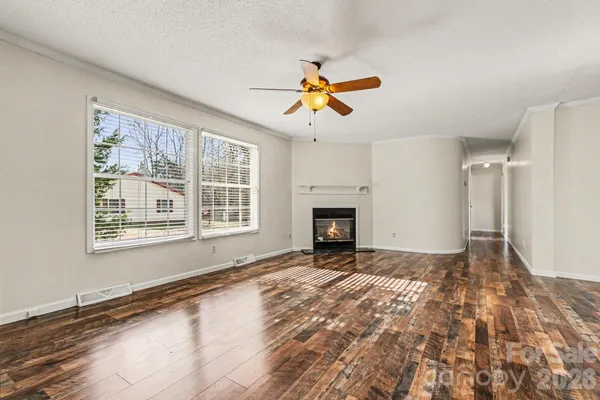a view of empty room with fireplace and fan