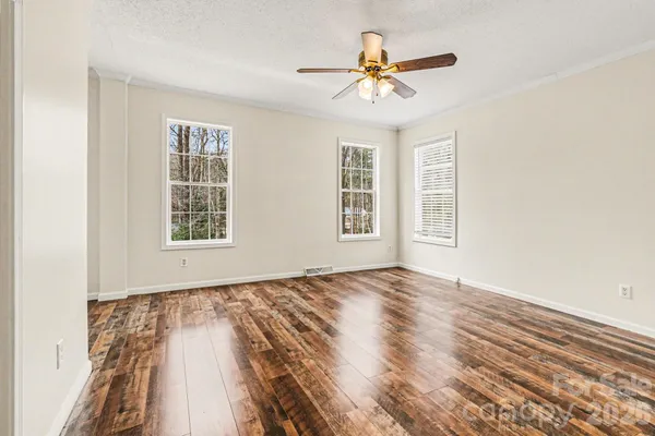 wooden floor in an empty room with a window