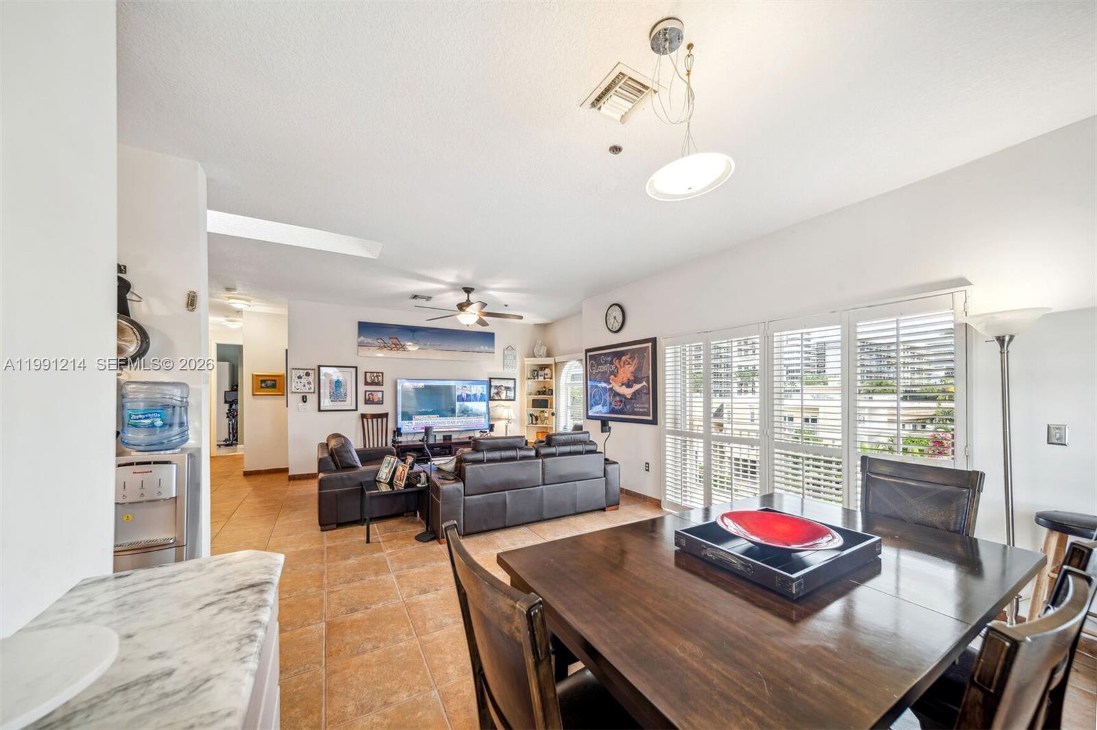 9008 Collins Avenue, Unit 402 Surfside, FL 33154 - Photo 11 of 62 a living room with furniture kitchen view and a large window