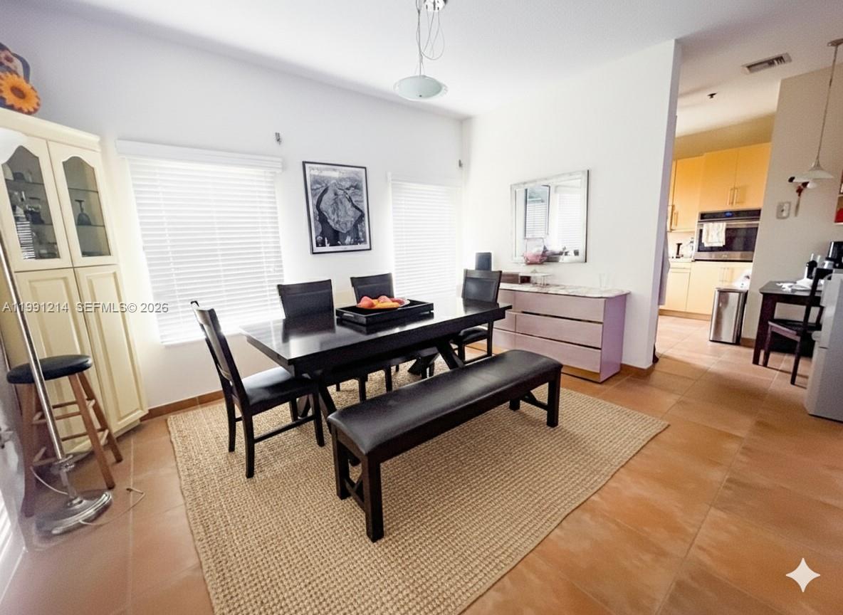 9008 Collins Avenue, Unit 402 Surfside, FL 33154 - Photo 14 of 62 a living room with furniture and a table