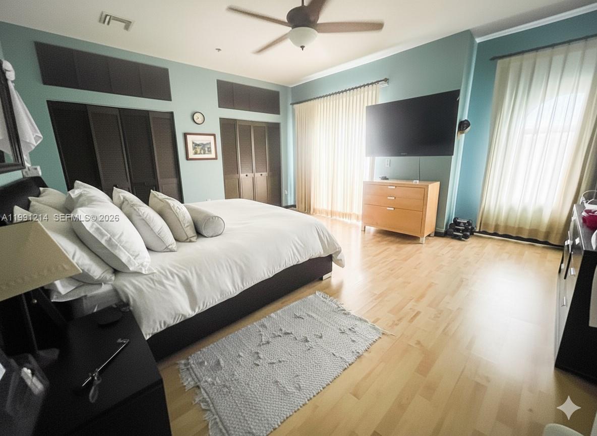 9008 Collins Avenue, Unit 402 Surfside, FL 33154 - Photo 26 of 62 a bedroom with a bed and a flat screen tv