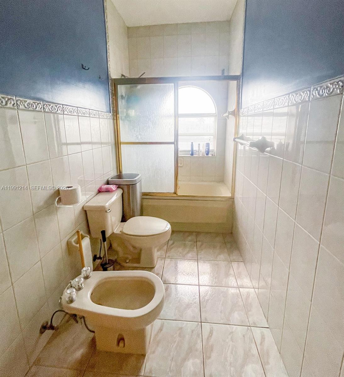 9008 Collins Avenue, Unit 402 Surfside, FL 33154 - Photo 27 of 62 a bathroom with a toilet and a shower