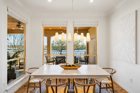 a view of a dining room with furniture large windows and wooden floor