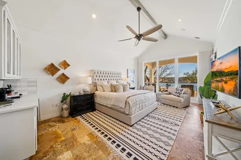 a bedroom with furniture and a flat screen tv