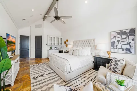 a bedroom with a large bed and a couch