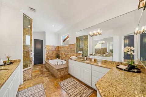 a large bathroom with a large tub and sink