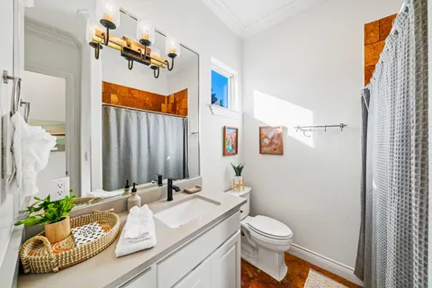 a bathroom with a sink toilet and shower