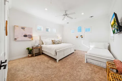 a bedroom with a bed a couch and a window