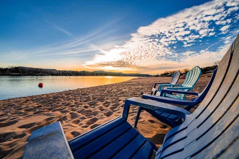 a view of a balcony with wooden floor and lake view