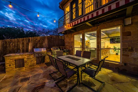 a view of a patio with table and chairs with wooden floor and fence