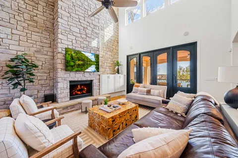 a living room with furniture fireplace and a large window