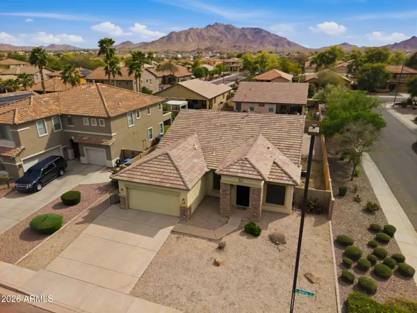 an aerial view of a house with a mountain