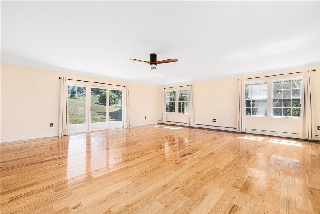 18 J H Dwyer Drive Middletown, RI 02842 - Photo 15 of 42 Den has sliders to the rear deck which runs the entire width of the house