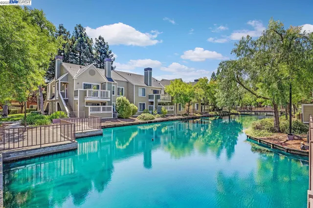 a view of residential house with outdoor space and lake