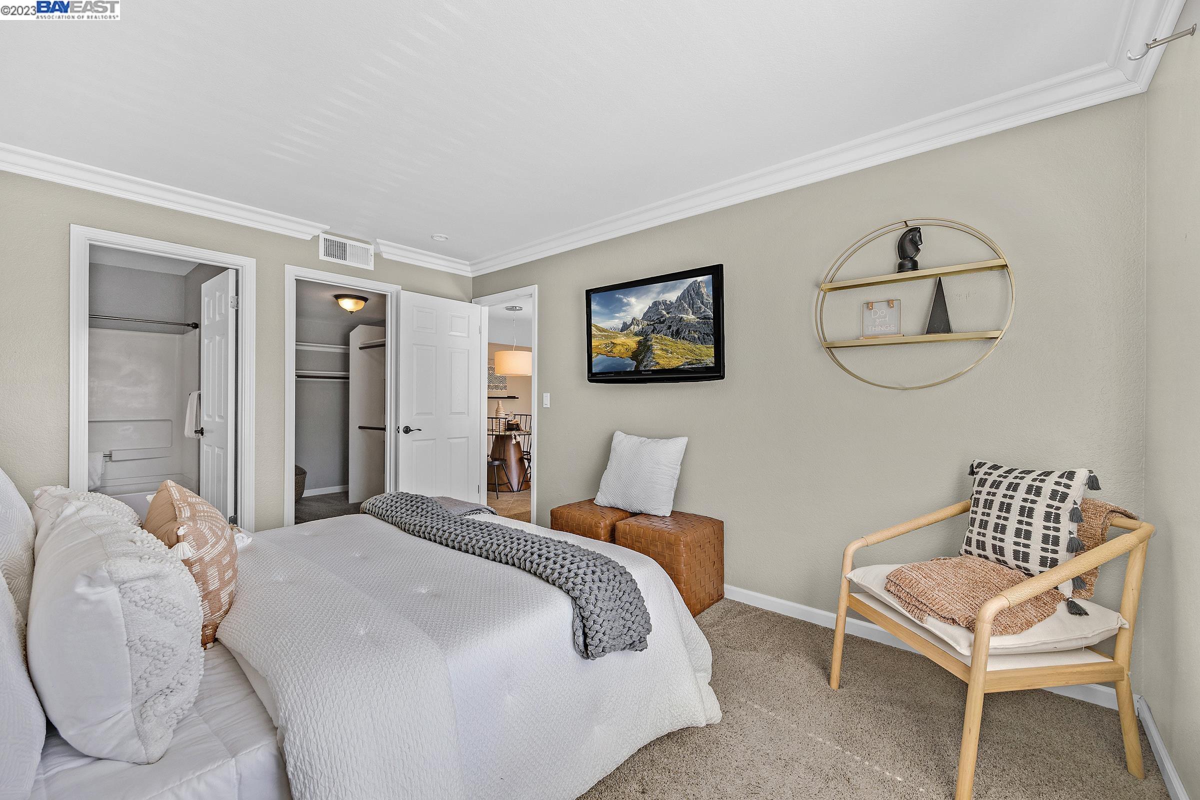 245 Reflections Drive San Ramon, CA 94583 - Photo 16 of 42 a bedroom with a bed and a chair