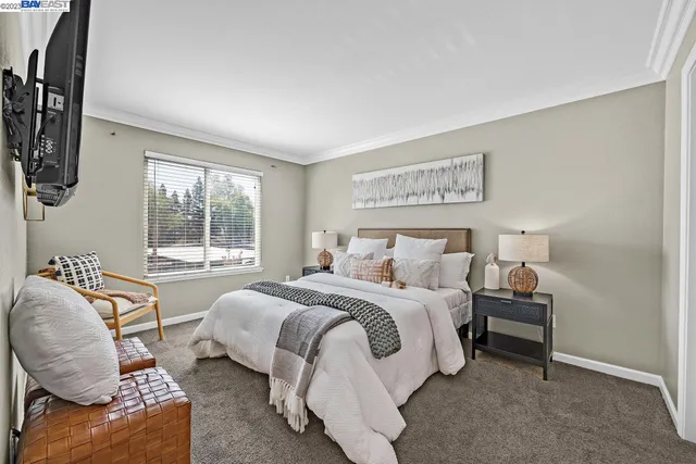 a bedroom with bed and glass window