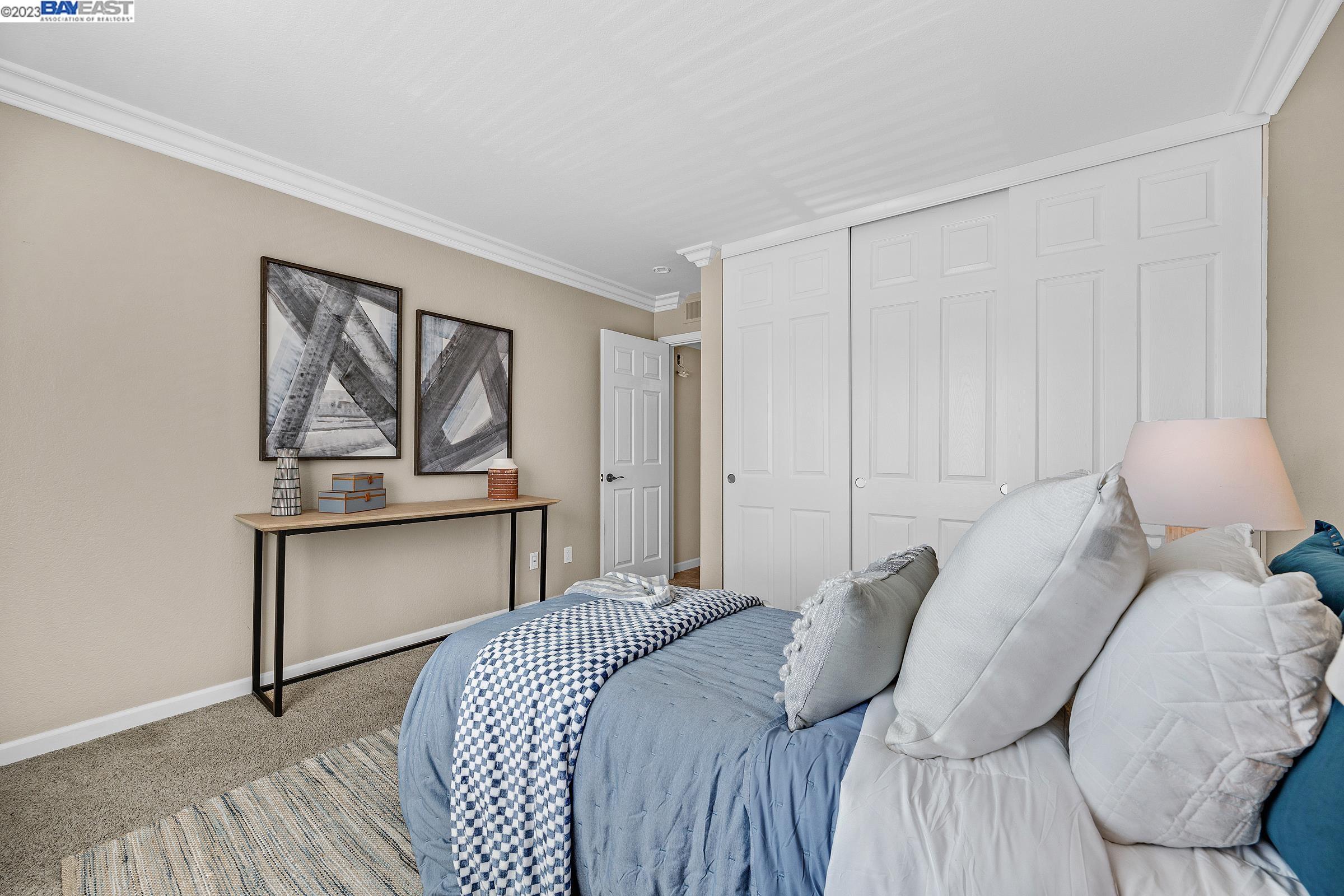 245 Reflections Drive San Ramon, CA 94583 - Photo 21 of 42 a bedroom with a bed and a painting on the wall