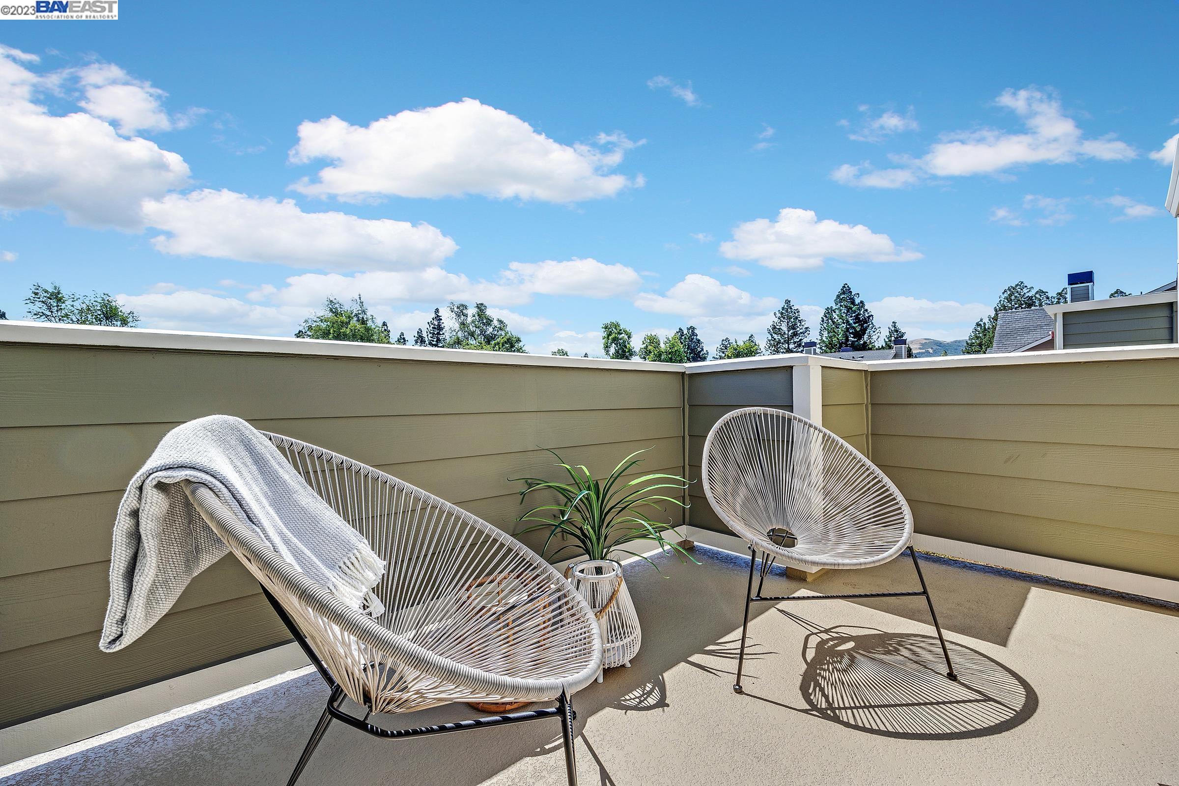 245 Reflections Drive San Ramon, CA 94583 - Photo 25 of 42 a balcony with wooden floor table and chairs