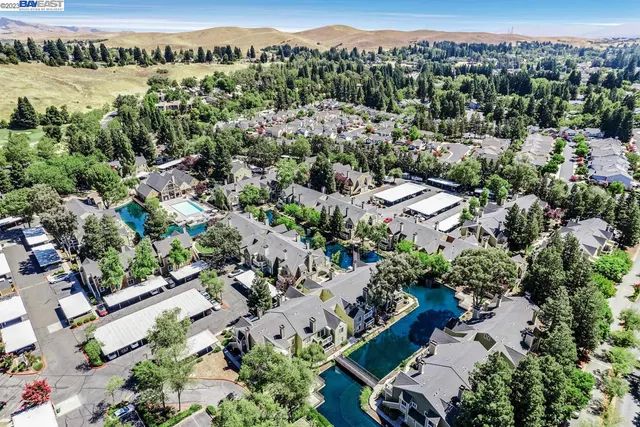 an aerial view of house with yard and lake view
