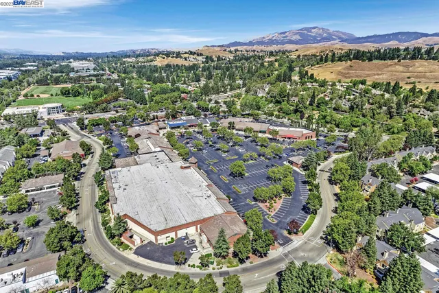 an aerial view of a residential houses with outdoor space and swimming pool