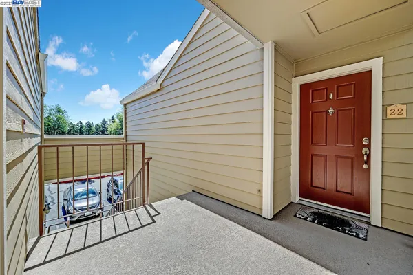 a view of a porch with a door and a rug