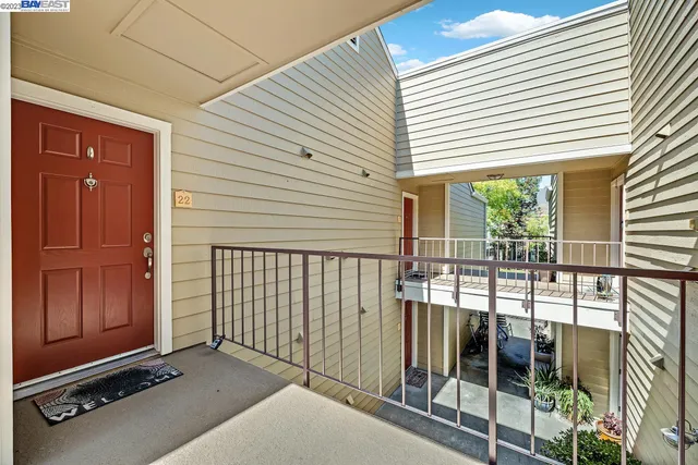 a view of a balcony with floor to ceiling windows