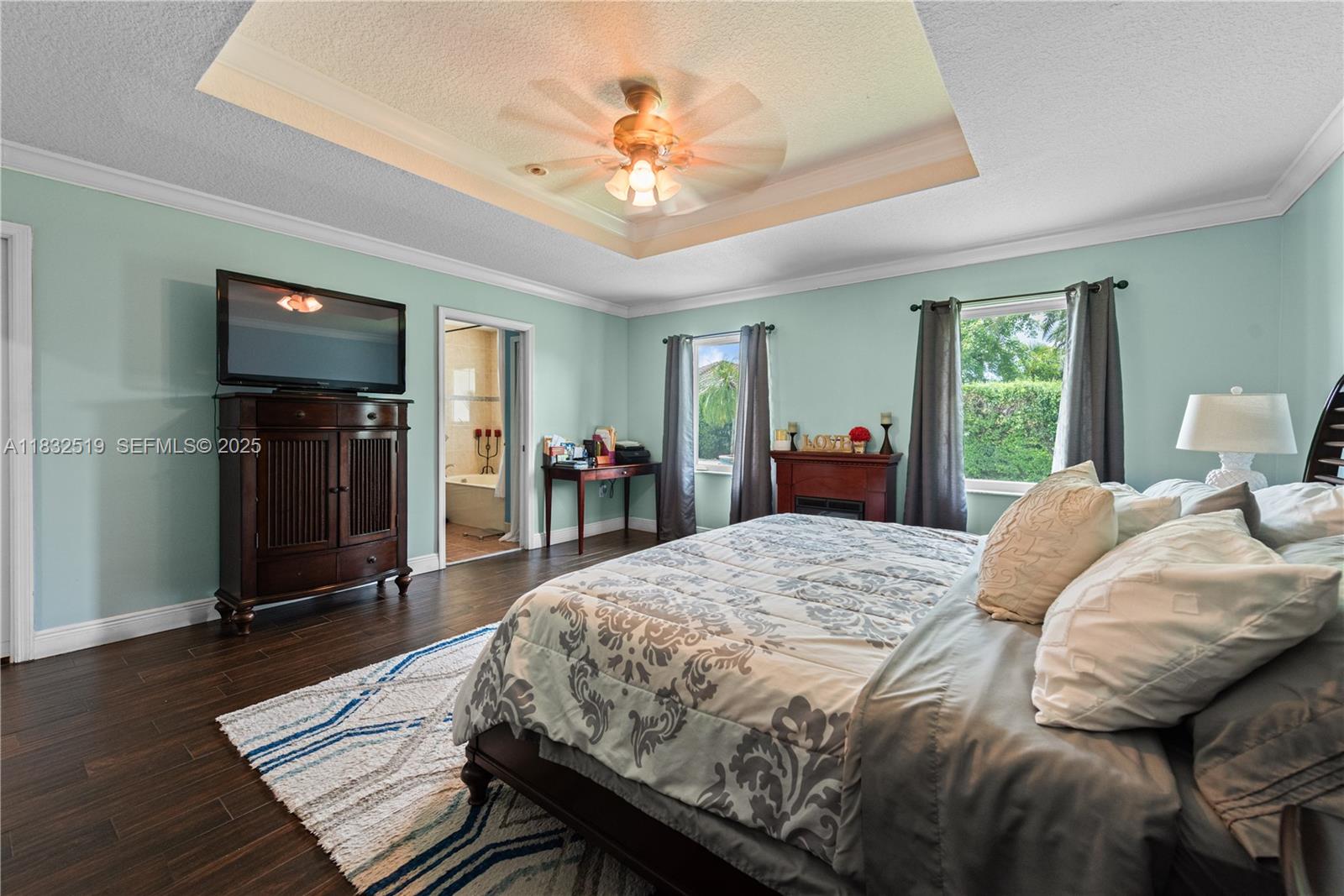 18740 Southwest 297th Street Homestead, FL 33030 - Photo 14 of 46 a bedroom with a bed and a chandelier