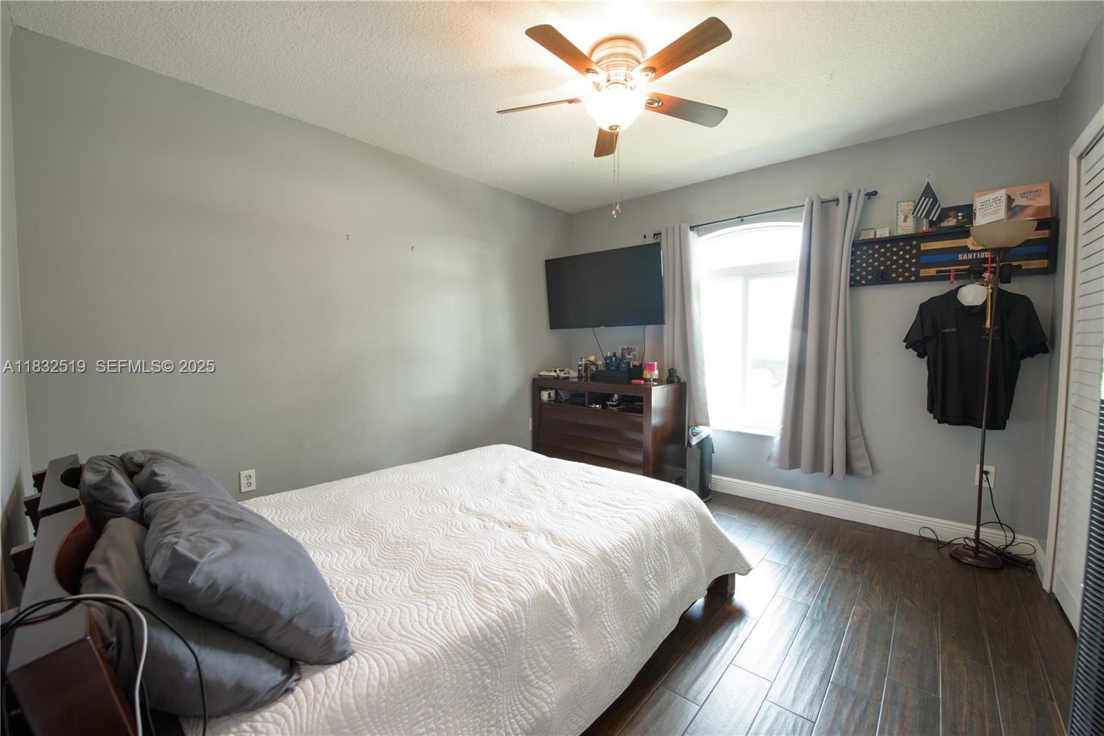 18740 Southwest 297th Street Homestead, FL 33030 - Photo 17 of 46 a bedroom with a bed and a chandelier