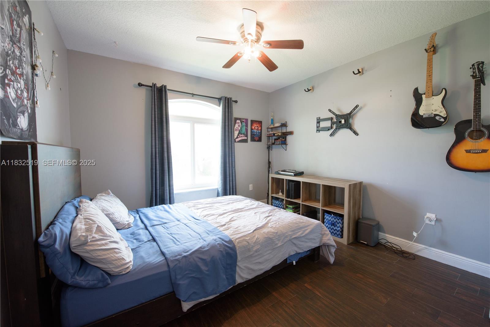 18740 Southwest 297th Street Homestead, FL 33030 - Photo 19 of 46 a bedroom with bed and a chandelier