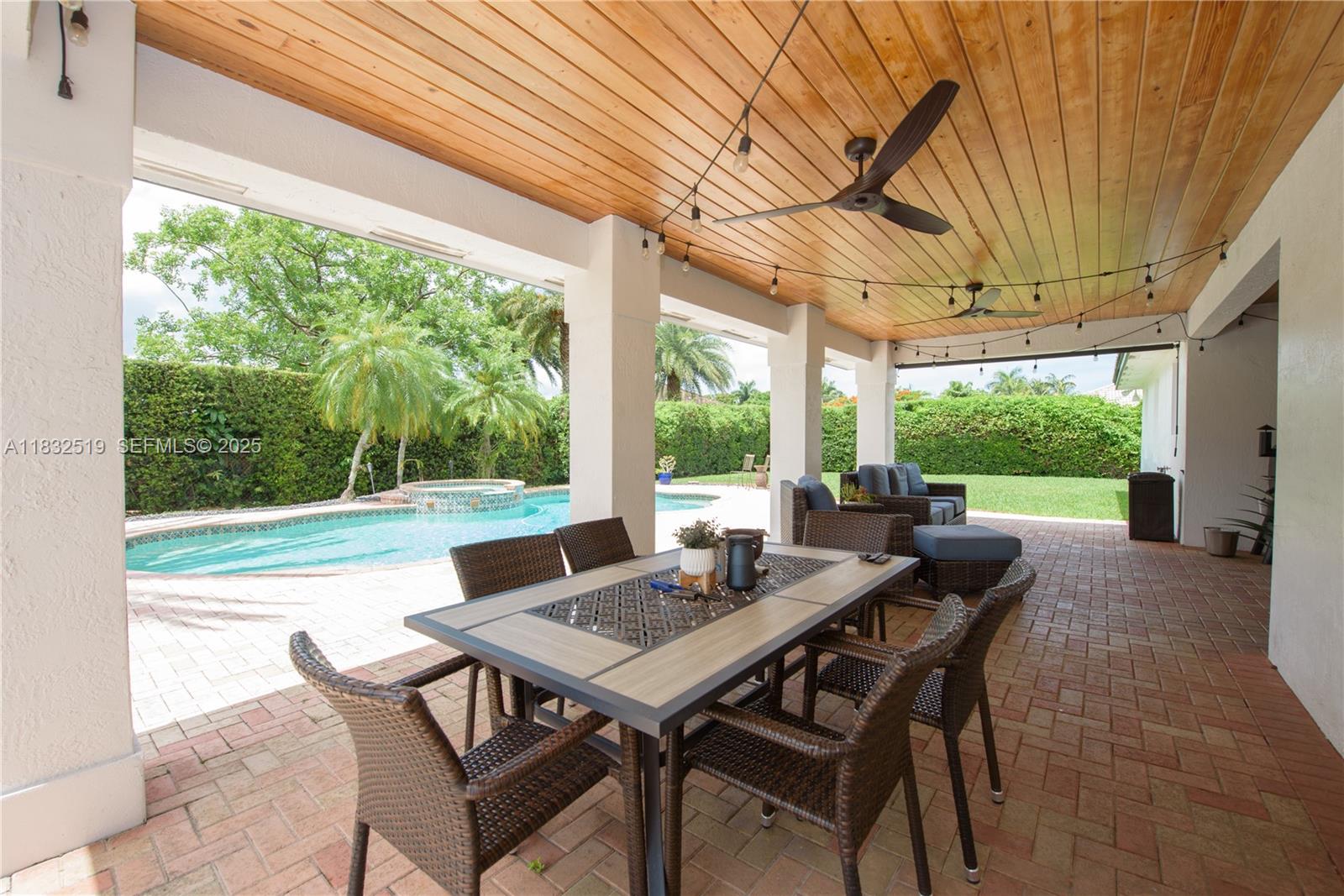 18740 Southwest 297th Street Homestead, FL 33030 - Photo 29 of 46 a view of a patio with a table chairs and a table