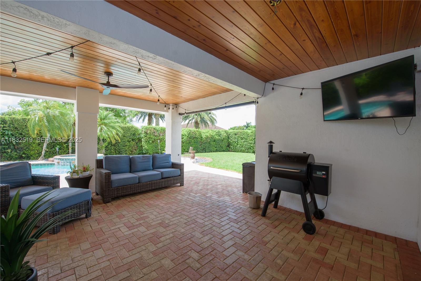 18740 Southwest 297th Street Homestead, FL 33030 - Photo 30 of 46 a living room with patio furniture and a fireplace