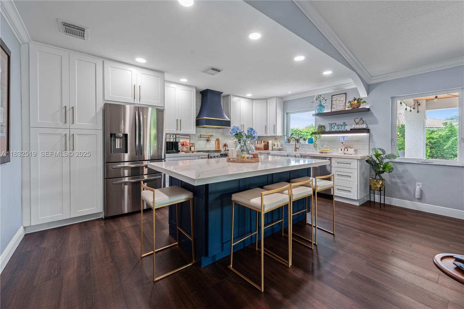 18740 Southwest 297th Street Homestead, FL 33030 - Photo 3 of 46 a kitchen with stainless steel appliances kitchen island granite countertop a table chairs refrigerator and microwave