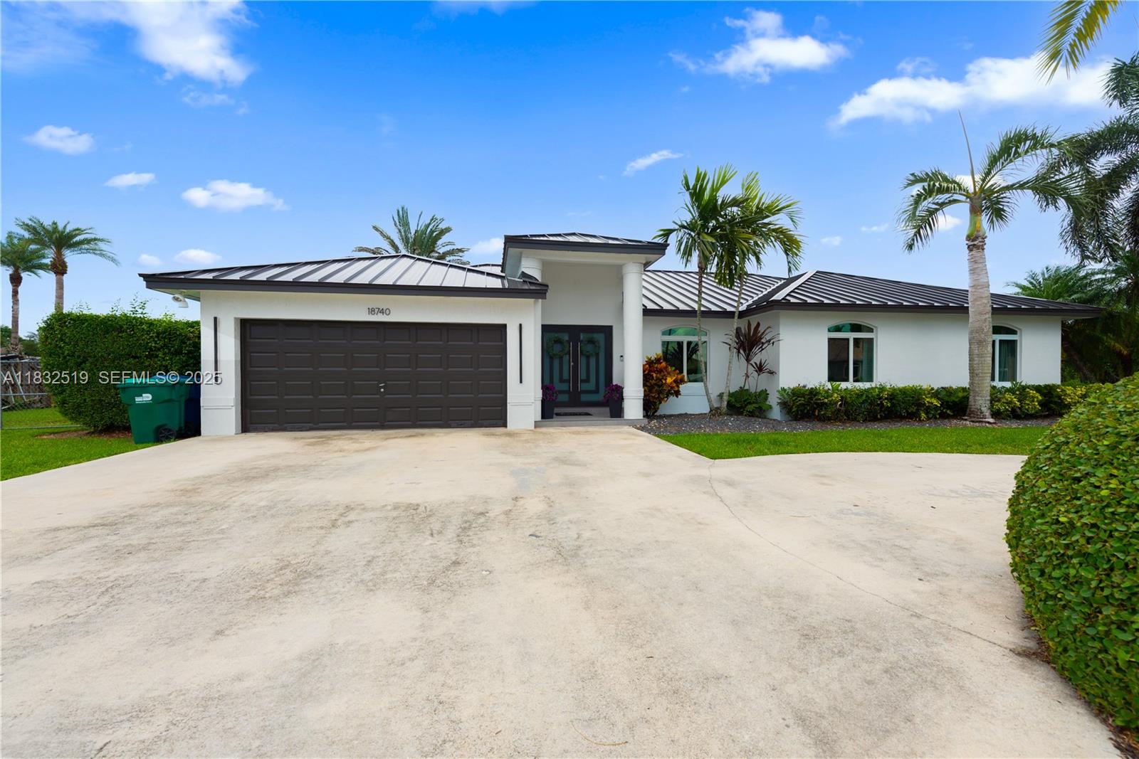 18740 Southwest 297th Street Homestead, FL 33030 - Photo 31 of 46 a front view of a house with a yard and garage