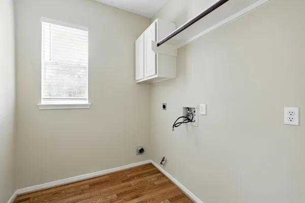 a view of a room that has a fan and wooden floor