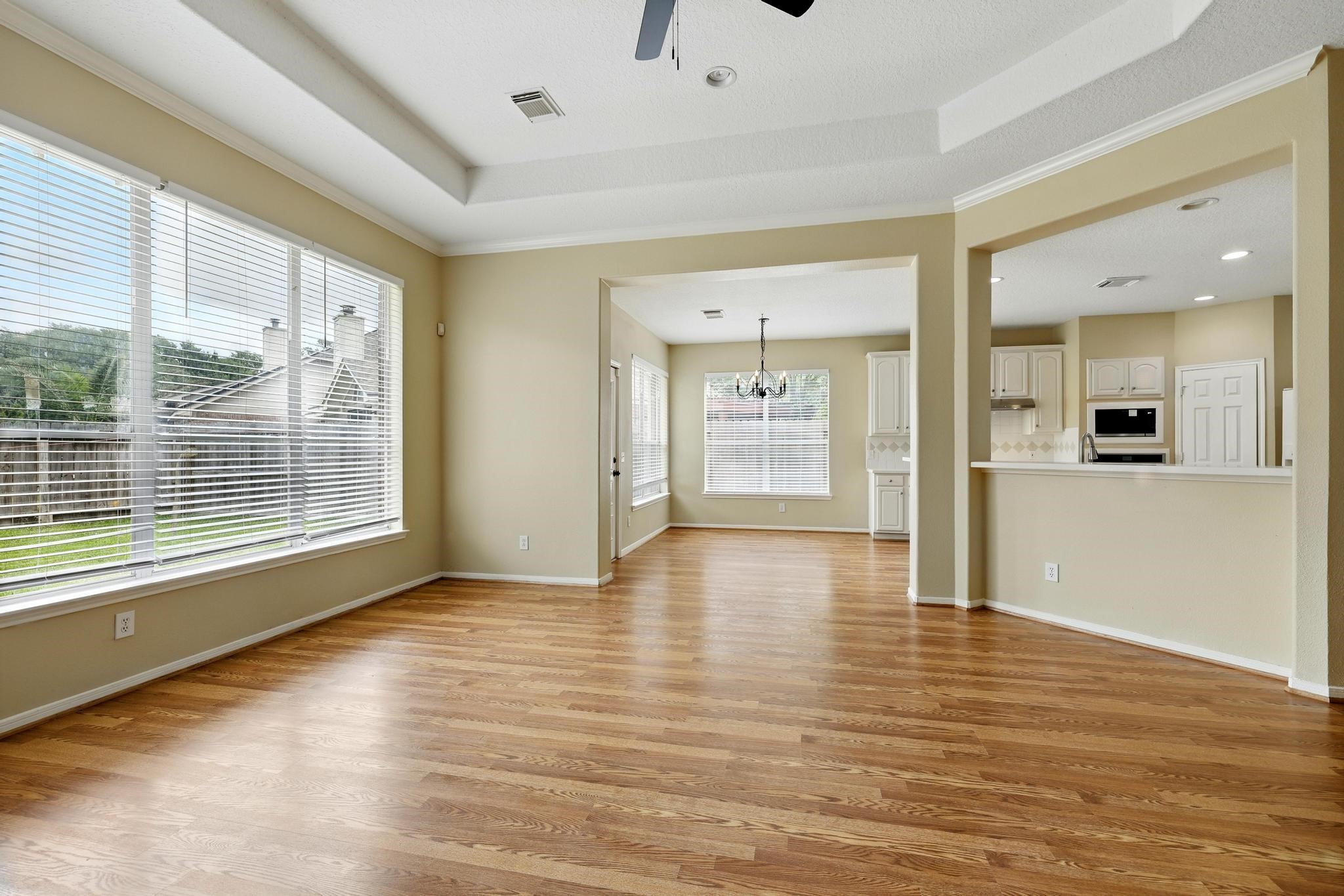11030 Sprucedale Court Houston, TX 77070 - Photo 16 of 36 a view of an empty room with wooden floor and a window