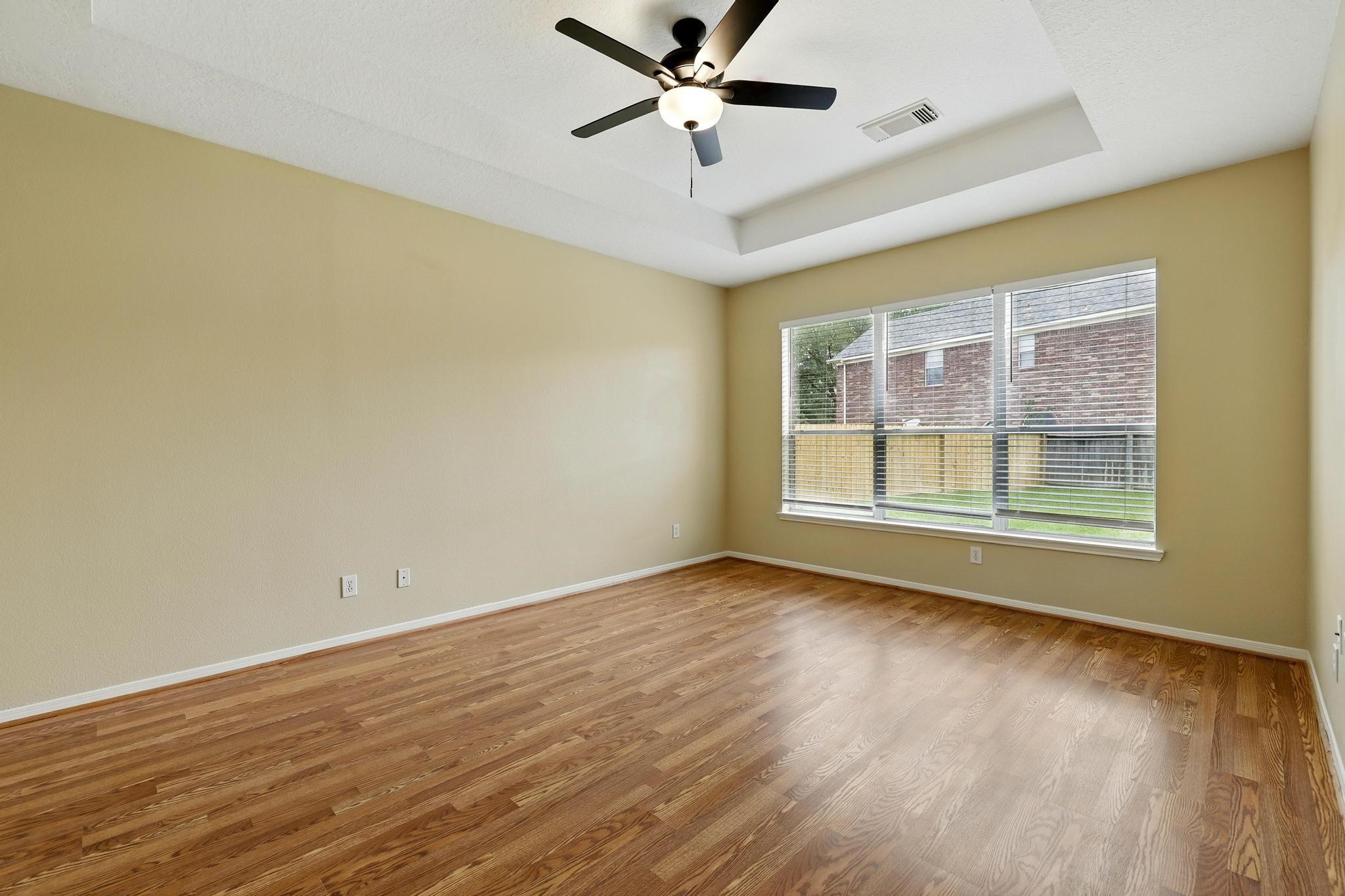 11030 Sprucedale Court Houston, TX 77070 - Photo 17 of 36 a view of wooden floor and a chandelier fan in a room